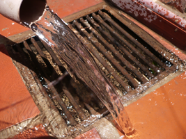 plumbing contractor tests clogged floor drain